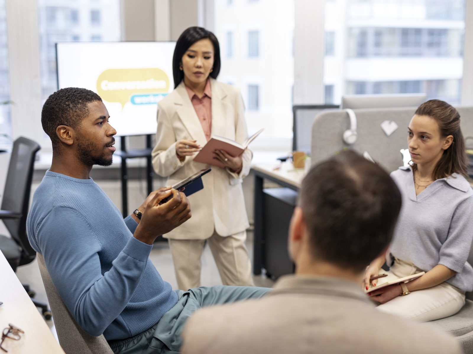 Public relations specialists talking through a communications plan in an office meeting